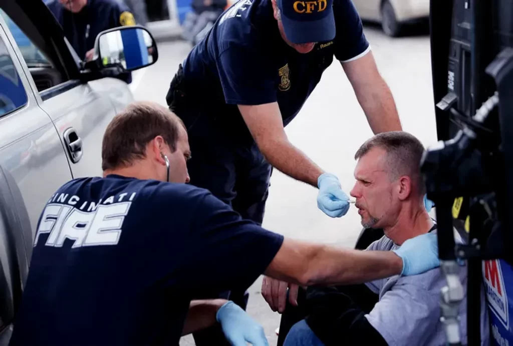 First responder administering naloxone